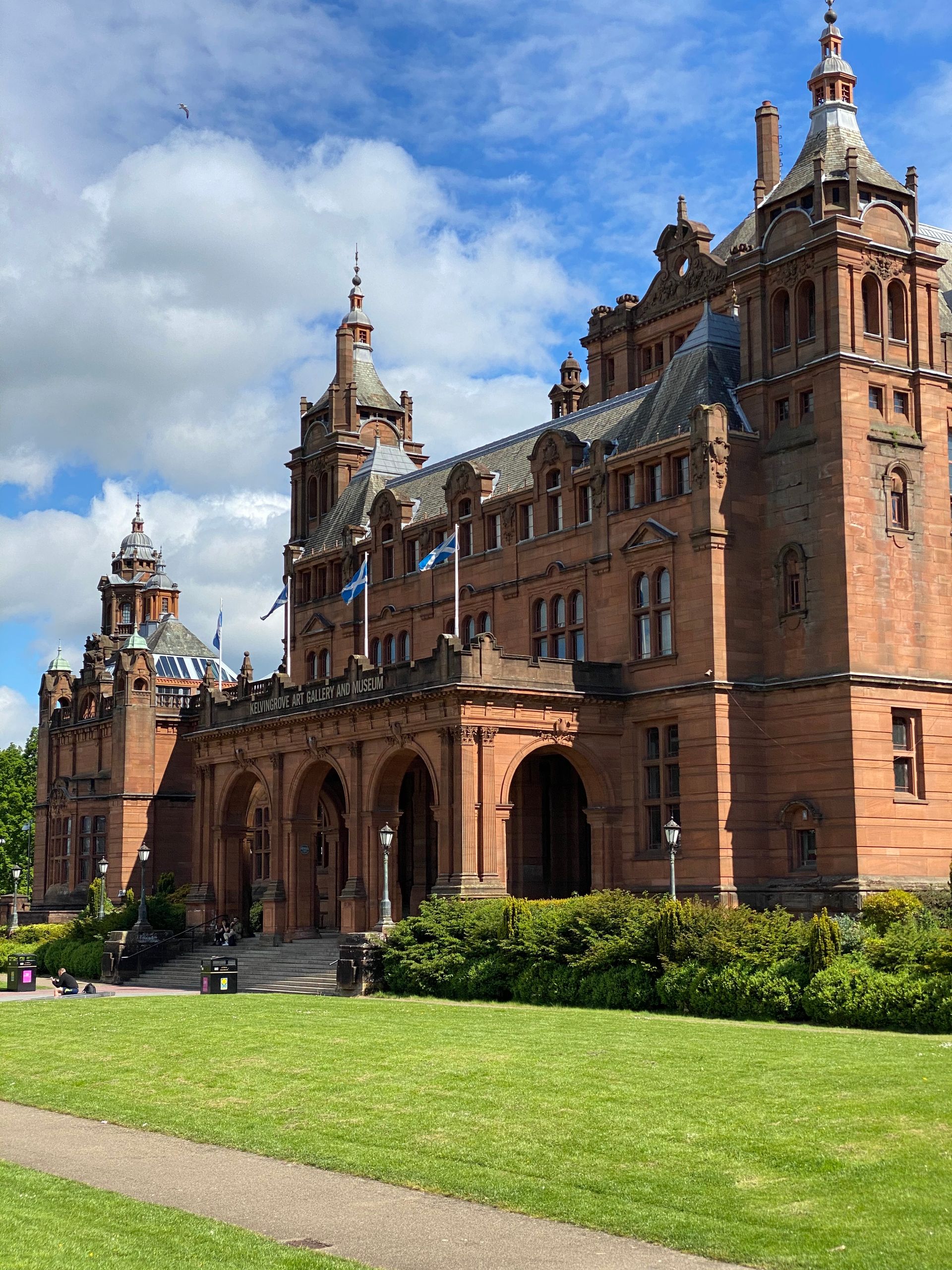 Stunning architecture of Kelvingrove Art Gallery in Glasgow under a blue sky on a summer day.